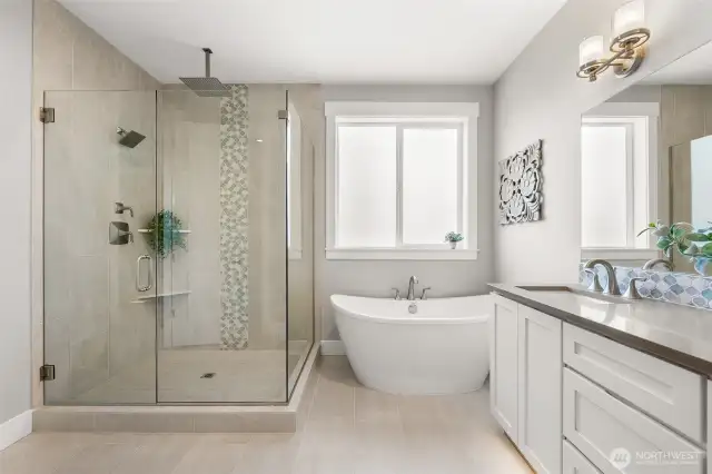 Soak your cares away, or take a lingering shower in the stunning glass enclosed tile shower.