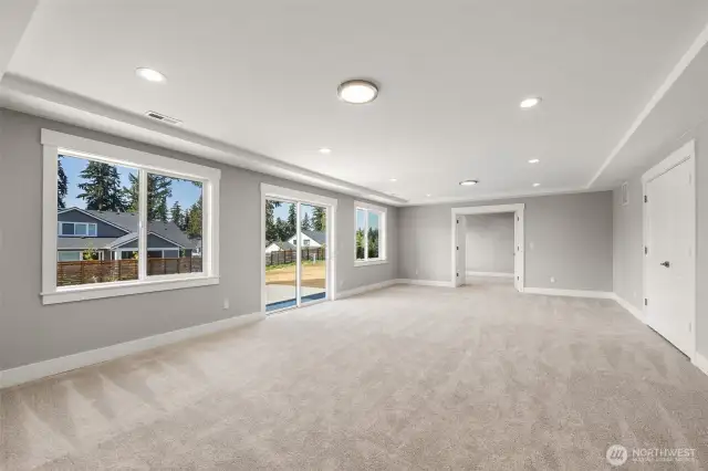 Sliding glass doors open on to the lower level patio, while french doors lead into an extra flex room.