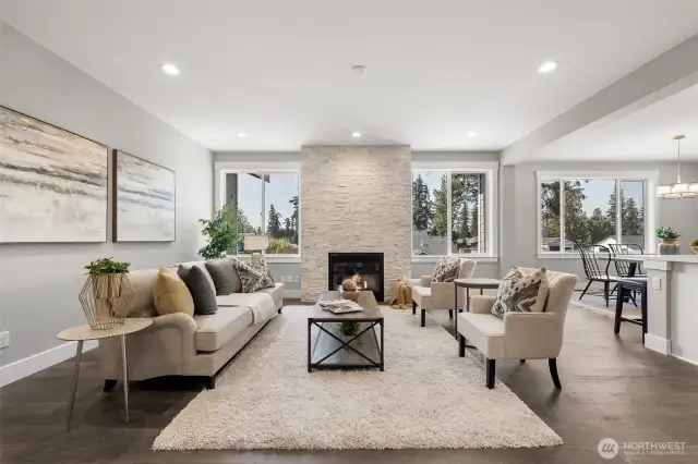 The inviting living room is luxurious yet comfortable.  The floor to ceiling stone fireplace is a stunning centerpiece to this beautiful space.