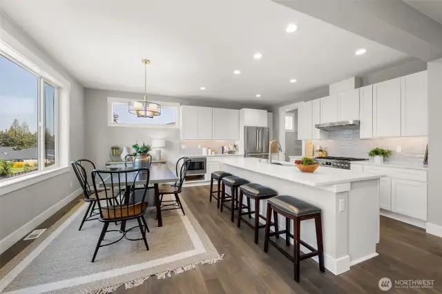 The gracious dining space just off the kitchen is suited for both formal and informal dining. Extra seating at the oversized breakfast bar island for casual meals or chats.