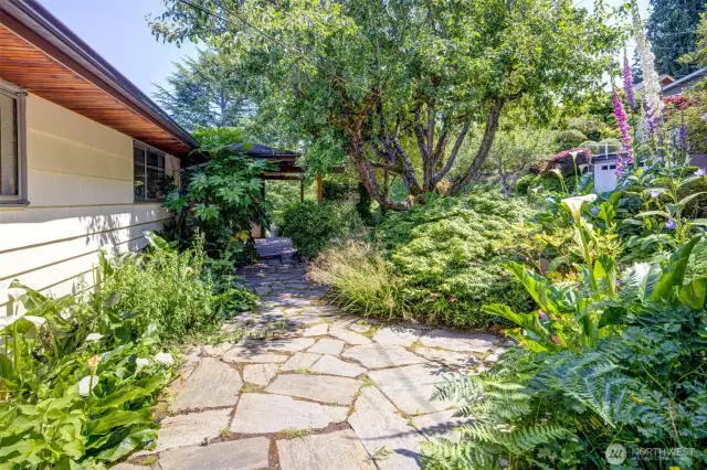 Landscaped patio space in the center of soft lush gardens-a beautiful way to start the day with morning coffee.