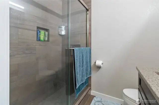 Walk in tiled shower.