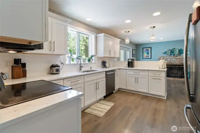 Bright kitchen with a pantry next to fridge.