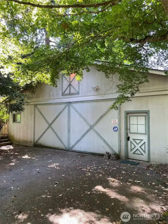 "Front" side of house with four car garage.