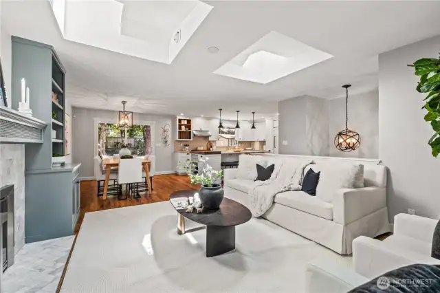 The cozy living room flows seamlessly into a dining nook and open kitchen space