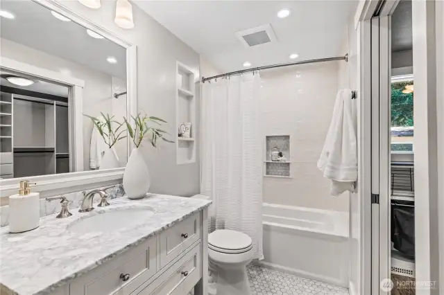 The primary ensuite bathroom features a modern designer vanity and bathtub perfect for relaxing after long days
