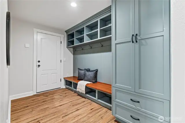 This smart mudroom entry with built-in storage and coat hooks will help keep everyday essentials organized as you come in from the garage