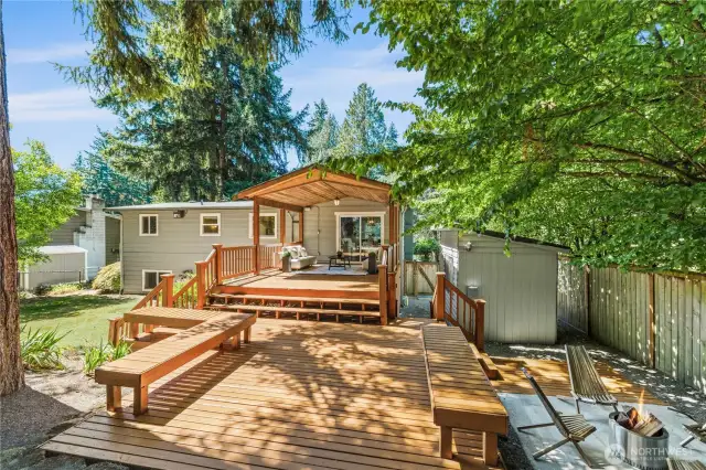 Your summer entertaining spot awaits - spacious deck and backyard ready for gatherings