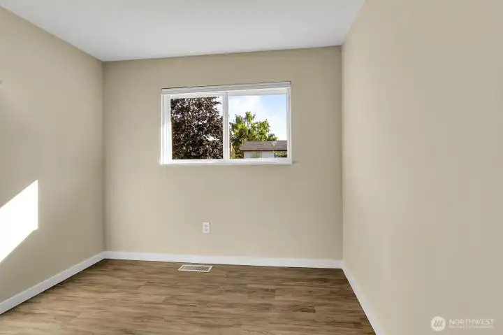 2nd upstairs bedroom  with vinyl plank flooring.