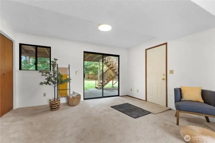 Lower level family rooms to the backyard thru sliding door.