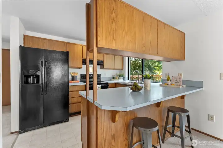 Open kitchen with breakfast bar.