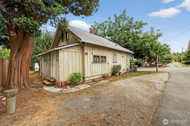 side of house with back door and shed