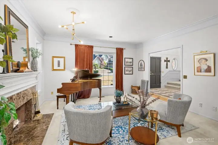 Formal living room with view into the grand foyer & Large Wood Burning Fire Place