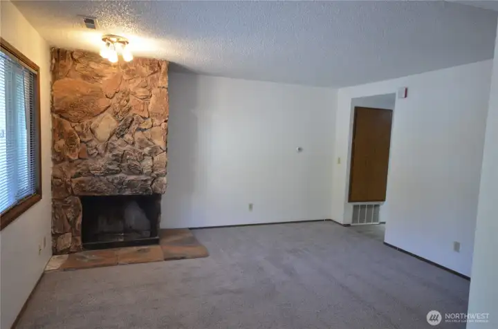 Living-rm with wood burning fireplace