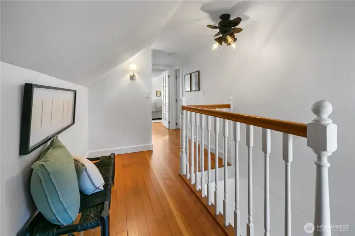 At the top of the stairs, looking straight ahead is one of two bedrooms on this level, the other bedroom is just to the right of the railing