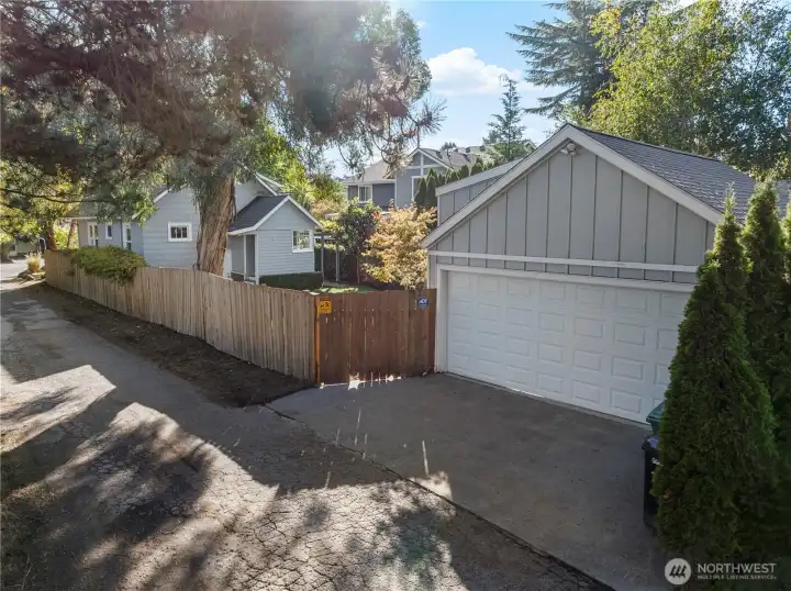 Exterior shot of the garage and a little bit of the house, as shown from the alley. Directly to the left of the shot are the playfields.
