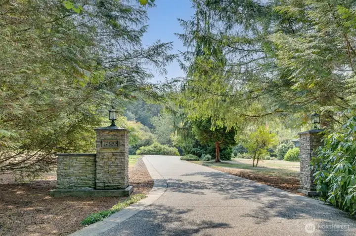 Gorgeous entrance welcomes you home, gracefully weaving through mature trees and lush acreage before arriving at this stunning residence.