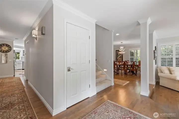 Expansive windows, and an abundance of natural light create a warm and inviting atmosphere. The foyer opens seamlessly into the sunken living room, where wide-open views of the property draw your eyes outward, instantly connecting the indoors with the beauty of the surrounding acreage.