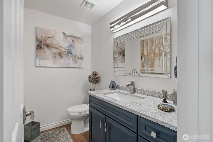 Conveniently located on the main floor, the half bathroom combines style and functionality. Elegant fixtures, thoughtful finishes, and a tasteful design create a space that is both practical for everyday use and visually appealing for guests. Its central location ensures easy access while maintaining the home’s overall flow and charm.