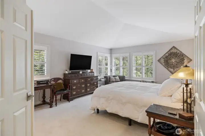 The primary bedroom is a serene retreat.  Spacious and filled with natural light, it features luxurious finishes, double door entry, expansive windows with picturesque views, and a thoughtfully designed layout that invites relaxation. With ample room for a sitting area or personal sanctuary, this primary ensuite offers a private haven to unwind and enjoy the beauty of the surrounding property.