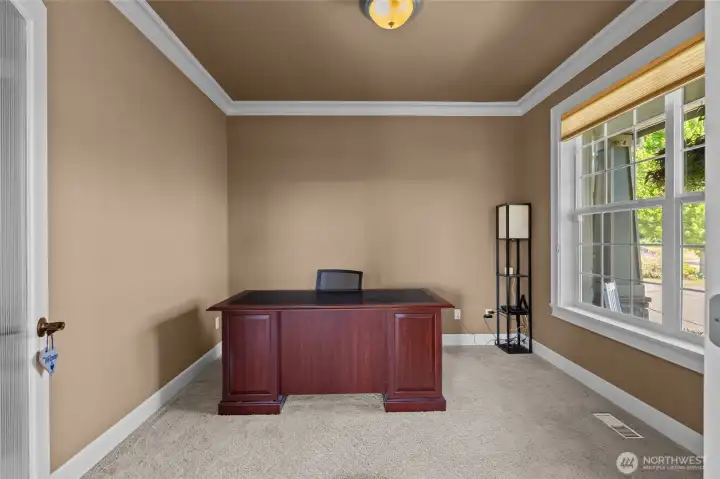 The main level offers this private office