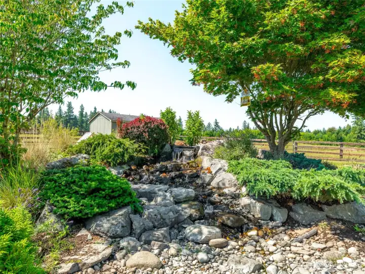 A beautifully designed water feature provides a peaceful focal point, adding both charm and tranquility to the grounds.