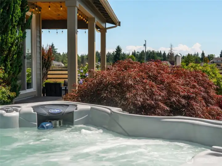 The new hot tub, positioned beside a serene water feature, offers a perfect combination of comfort and relaxation