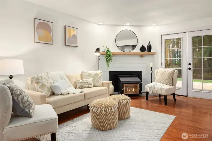French doors lead to new deck and private wooded back yard. Cozy wood stove warms the whole house.  Great cost saving benefit.