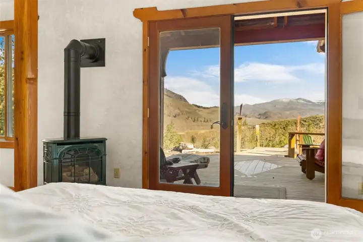 Wake up to this view! The primary suite includes a propane fireplace and french doors to a private porch steps away from the hot tub.