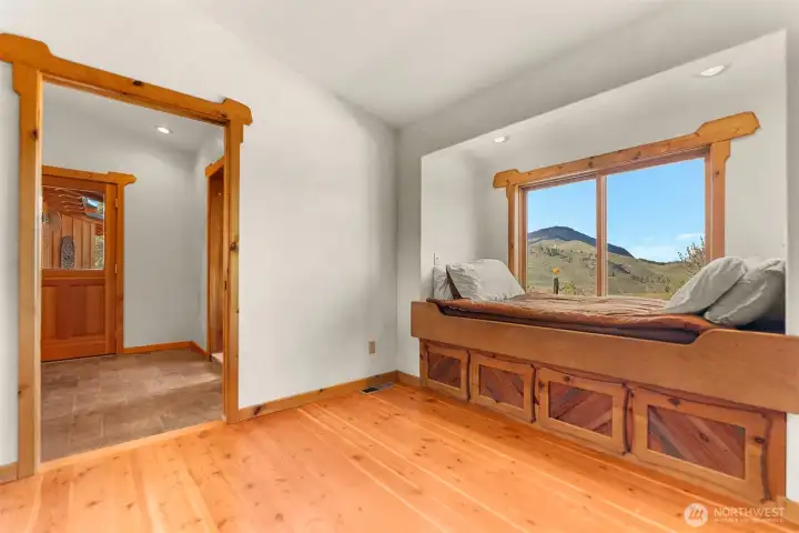 A second room on the other side of the primary bath is intended as a private sitting room or office and includes additional built in storage.