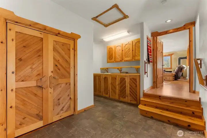 Conveniently located between the primary suite and the studio apartment, this space functions like a mudroom at the top of the stairs from teh garage - lots of storage here as well as an under-counter laundry area.