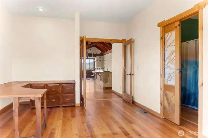 Off the kitchen, this versatile space can be office, library, or even additional sleeping space. The daylight basement is accessed through this room.