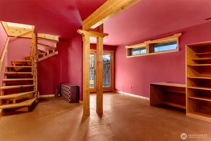 Daylight basement stays cool during the heat of summer. French doors access teh garden. Limited windows make this a great media room.