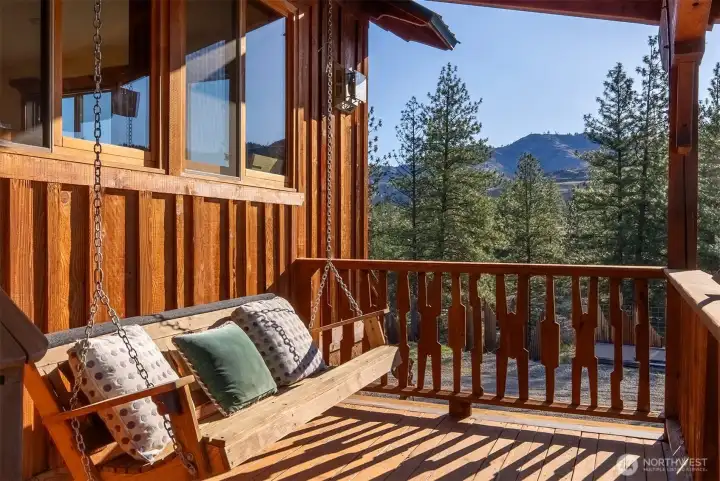 Pause awhile on this porch swing beside the private entrance to the studio apartment.