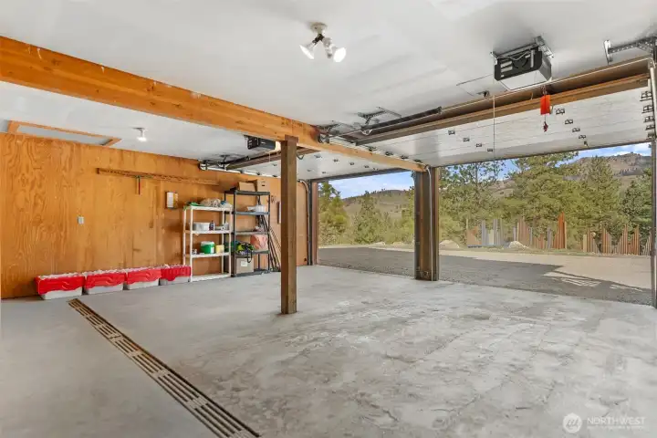 Practical two-car garage with floor drain and so much storage.