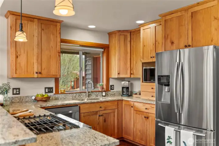 Granite countertops and stainless steel appliances.