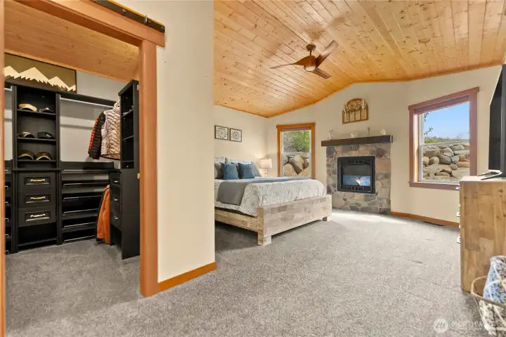 Walk in closet with quality organizational cabinetry in place.