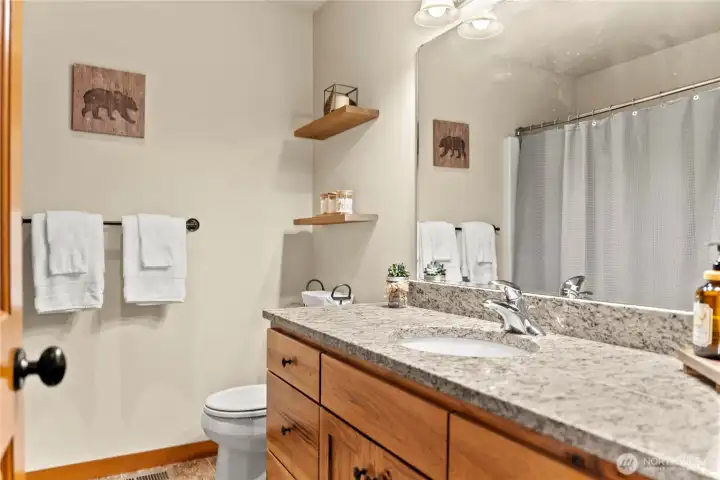 Upstairs full bathroom with granite countertops.