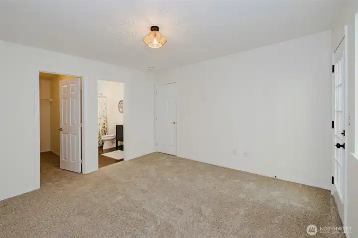 New carpet, lighting, a large walk-in closet large enough to fit your entire wardrobe and then some! Primary bath has a walk-in shower with a cascading waterfall shower heed, updated stylish vanity and light fixture. There's a door that leads to a small deck where you can sip coffee or read books and enjoy the privacy of a wooded greenbelt.