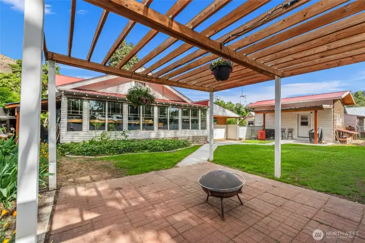 Pergola area in back yard. Looking at sun porch area of the house.