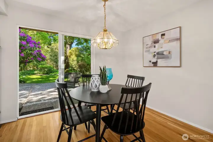 Dining opens up to curated and mature landscaping off patio.