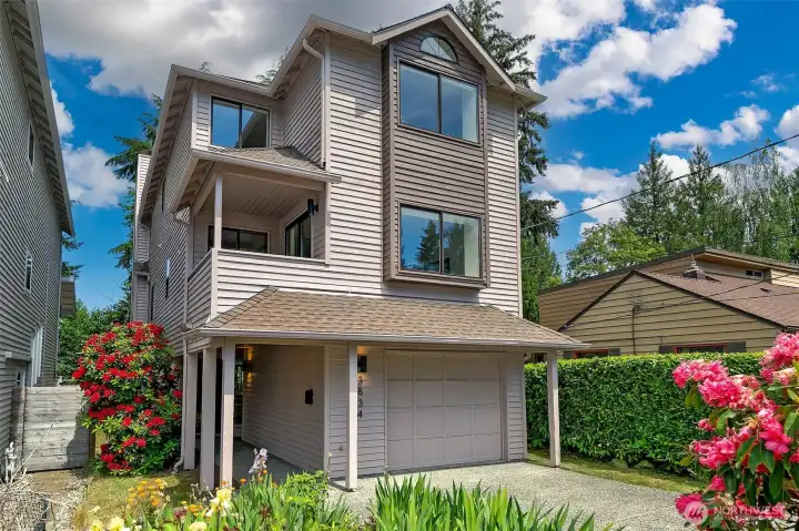 Sophisticated multi-level contemporary design on a quiet, tree-lined street in the heart of Wedgwood, offering space, privacy and the ease of low-maintenance living.