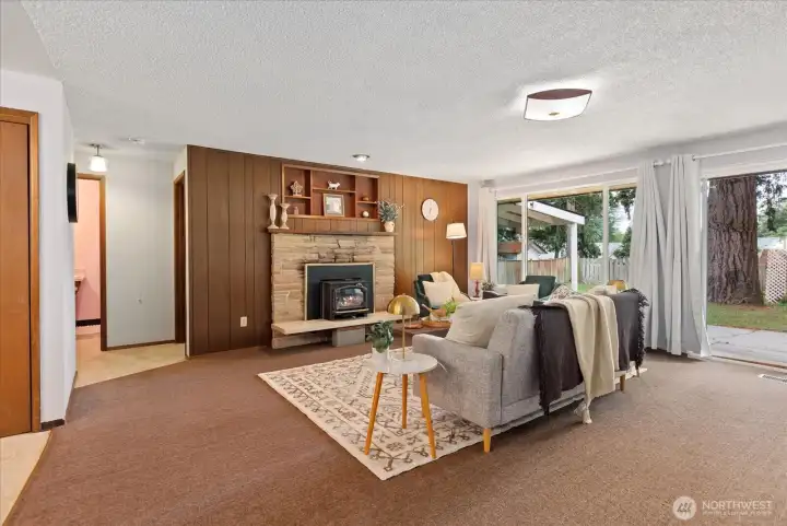 Living room showcasing classic wood paneled accent wall and new slider door. Living room showcasing classic wood paneled accent wall and new slider door.