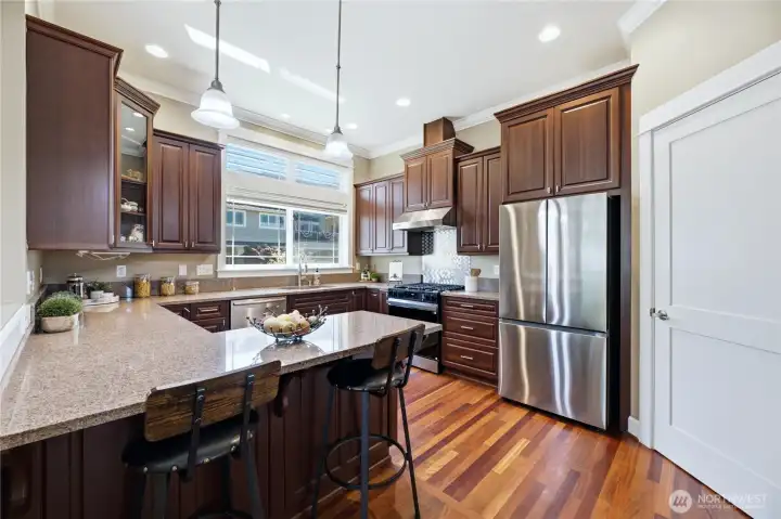 This gorgeous kitchen has upgrades galore!  Rich cabinetry, updated lighting, newer appliances, stunning floors