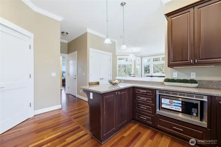 Upgraded lighting, a large, walk-in pantry, stunning floors, newer appliances, this is such a beautiful kitchen