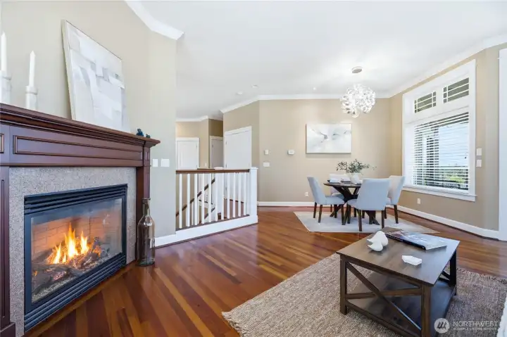 Spacious living room with gas fireplace steps out to deck with water views