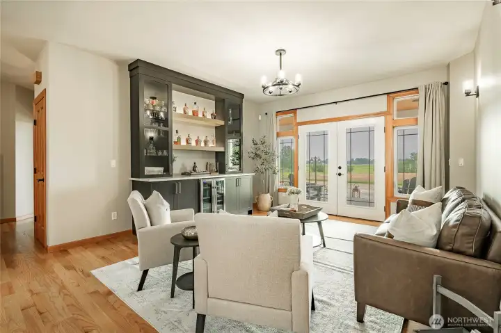 Sitting room opens out through the french doors to the expansive back covered patio. Sitting room opens out through the french doors to the expansive back covered patio.