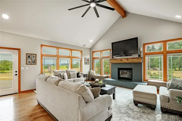 Vaulted great room with lots of natural light and newly tiled gas fireplace & ceiling fan. Vaulted great room with lots of natural light and newly tiled gas fireplace & ceiling fan.