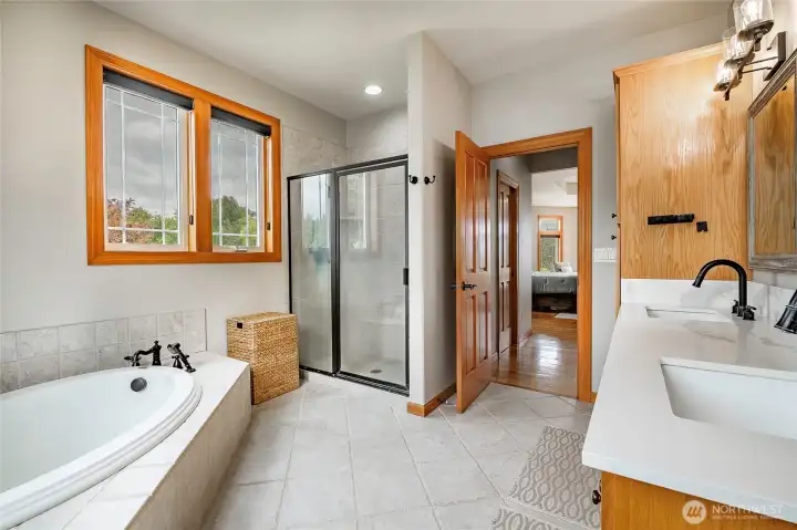 Primary bathroom features double sinks, shower and soaking tub. 2 separate closets are between the primary bedroom and bathroom. Primary bathroom features double sinks, shower and soaking tub. 2 separate closets are between the primary bedroom and bathroom.
