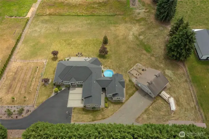 Ariel view of the home and barn. Not showing below is the shop/RV storage building & garden shed. Ariel view of the home and barn. Not showing below is the shop/RV storage building & garden shed.